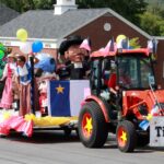 A float drives down Main Street in Madawaska during the Acadian Festival Parade on Sunday, Aug. 13. The float advertised the traditional tintamarre, where folks march through streets making fanfare with improvised instruments and noisemakers, which was to be held on Tuesday, Aug. 15, during National Acadian Day. (Courtesy of Elizabeth Theriault)