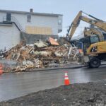 A residential building on the corner of 14th Avenue and Main Street in Madawaska is being demolished by Ed Pelletier & Sons as part of the Midtown Plaza Demolition deal on Apr. 26. (Emily Jerkins | St. John Valley Times)