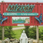 Mizpah's welcome sign greets visitors to the Grand Isle site.